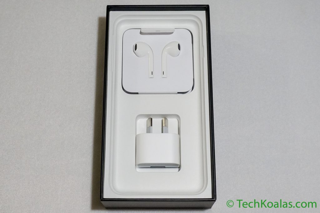 Under the phone you there are the earpods, lightning to headphone jack adapter, lightning to USB cable and a wall charger.