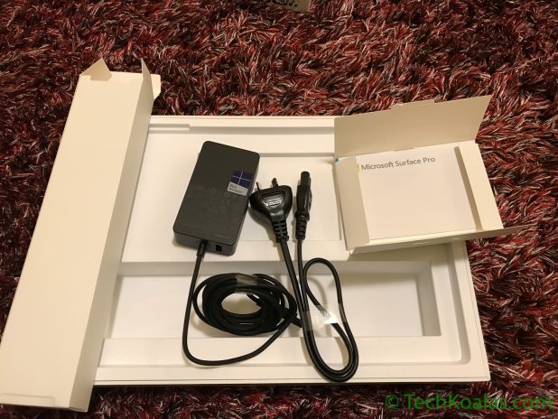 Figure 6. Microsoft Surface Pro - Power adaptor, wall cord and warranty papers.